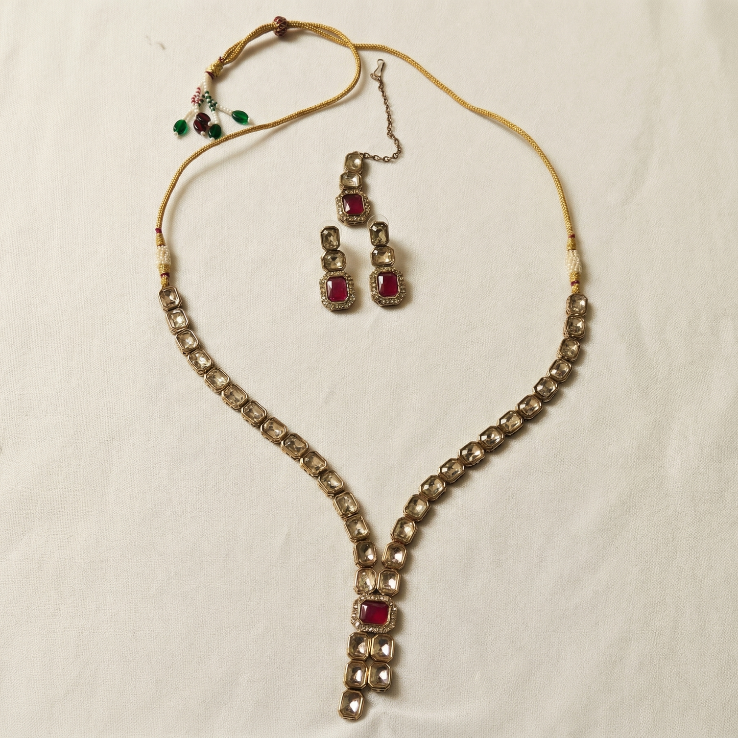 Jewelry set with necklace and earrings on a light background
