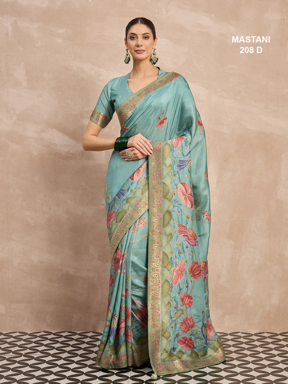 Woman wearing a light blue saree with floral patterns on a beige background