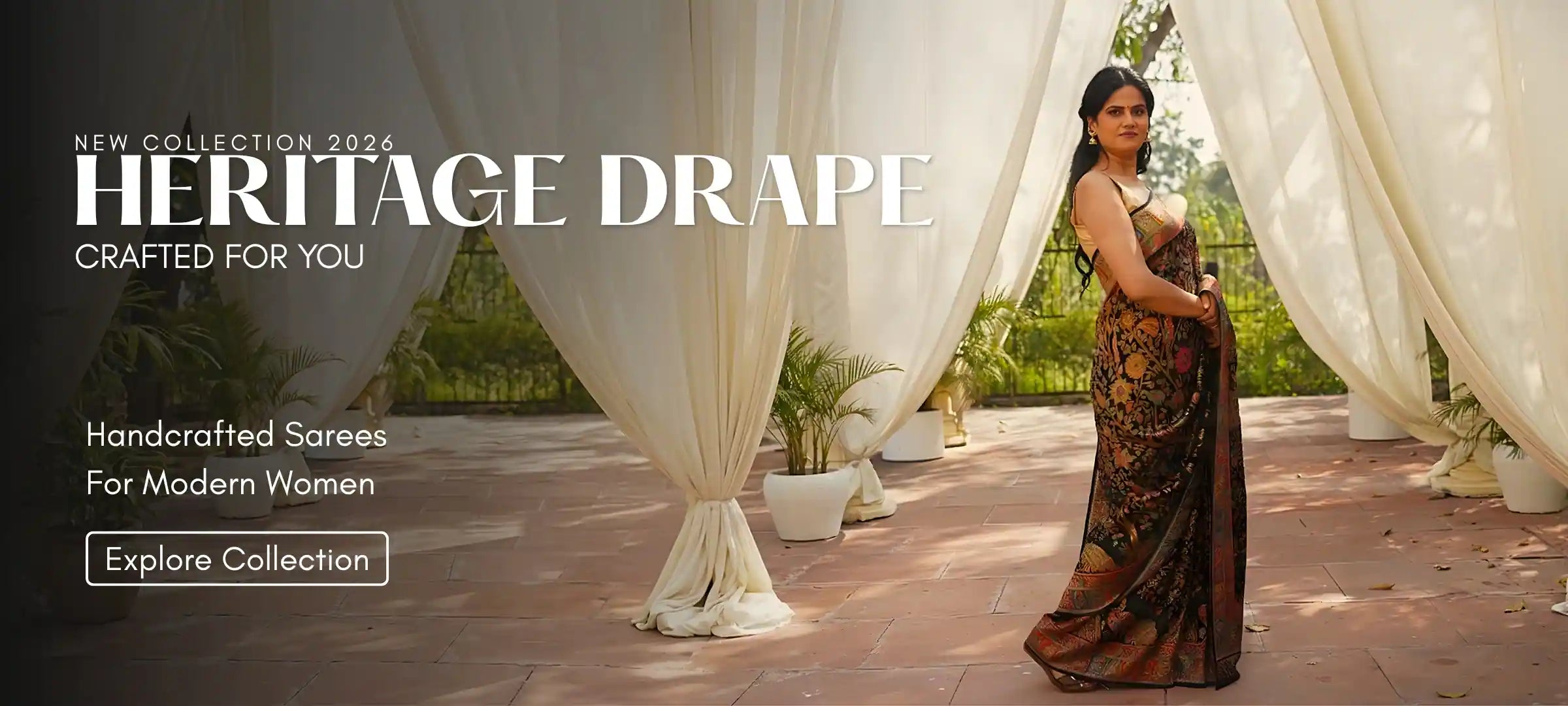 Woman in a saree standing in front of white curtains with 'Heritage Drape' text overlay.