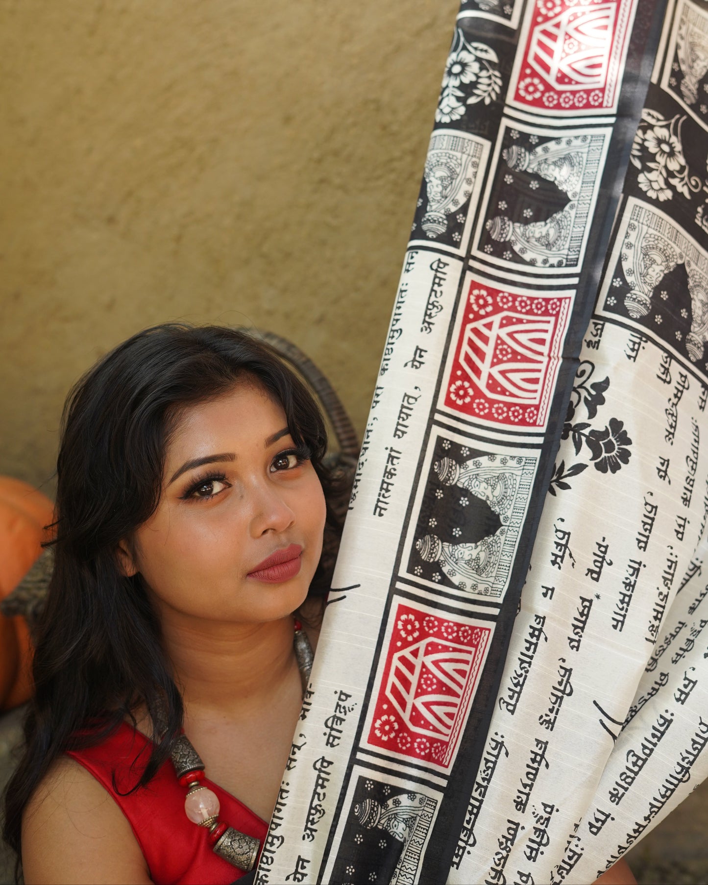Woman lying on a decorative mat with intricate patterns and text