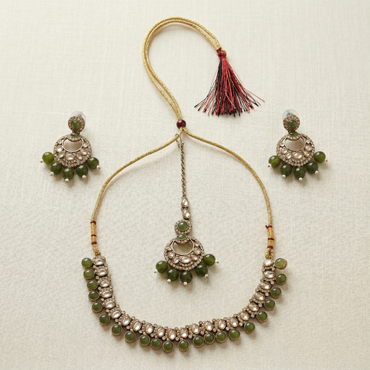 Jewelry set with necklace and earrings on a textured beige background