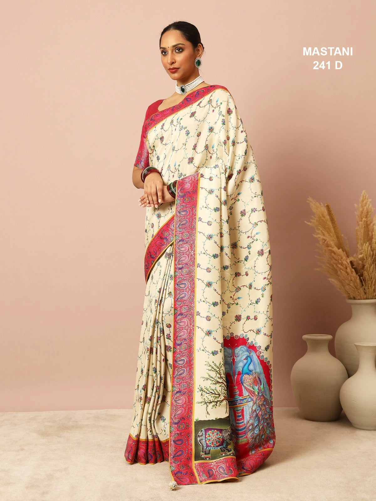 Woman wearing a traditional saree with a decorative border against a beige background