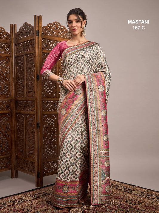 Woman wearing a patterned saree with a wooden screen and beige wall in the background