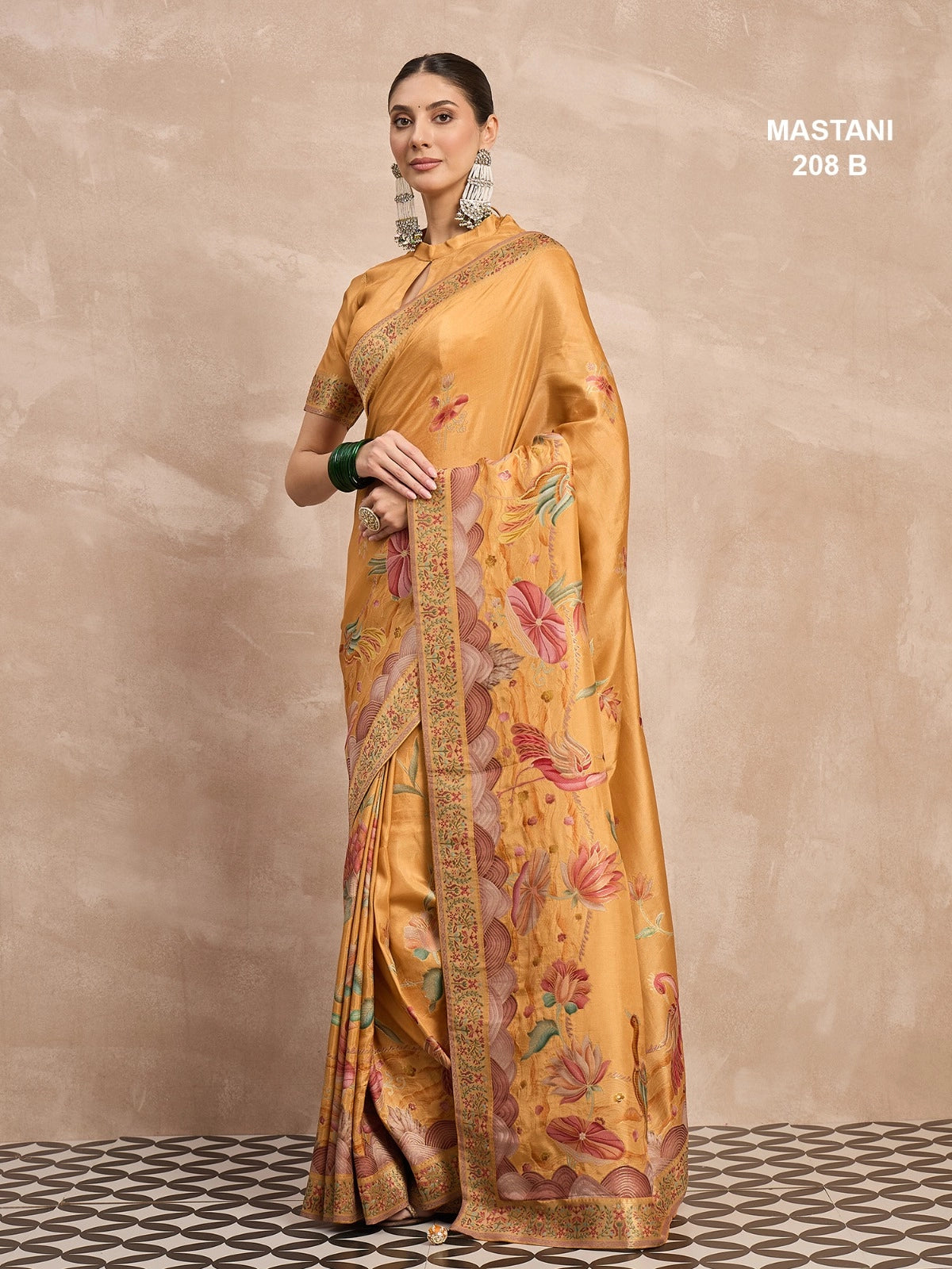 Woman wearing a yellow saree with floral patterns on a beige background