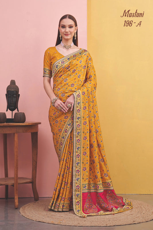 Woman wearing a yellow saree with a pink background