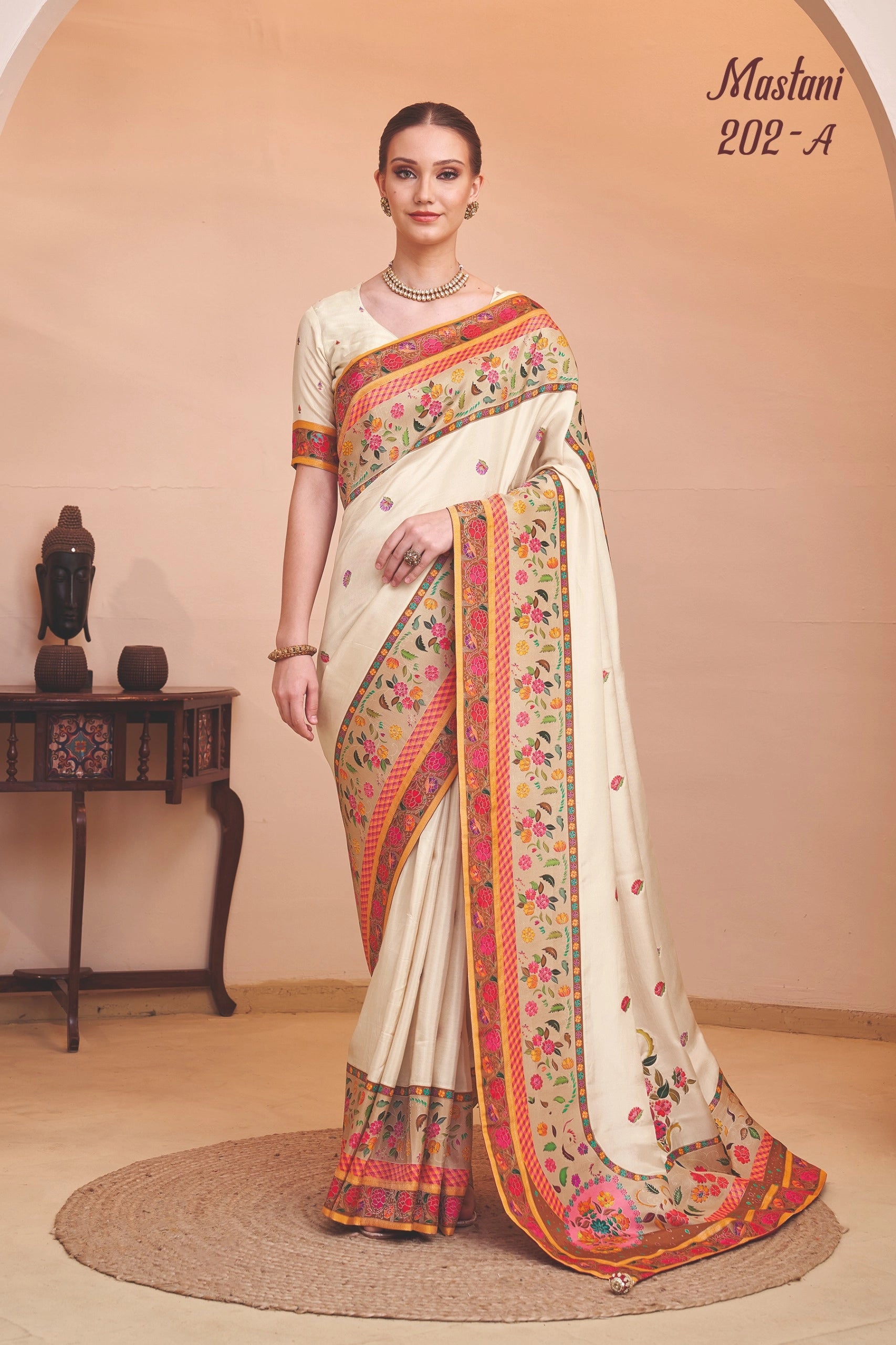 Woman wearing a traditional saree with floral patterns in a room setting