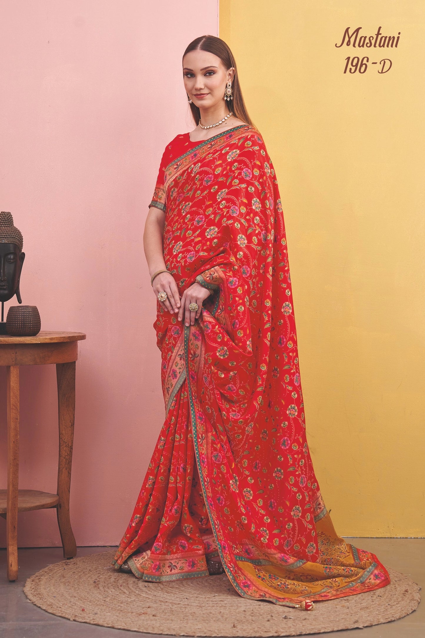 Woman wearing a red saree with a yellow background
