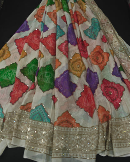 Colorful embroidered fabric with floral patterns on a dark background