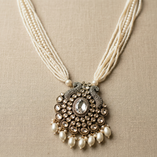 Necklace with a decorative pendant and pearl strands on a beige background