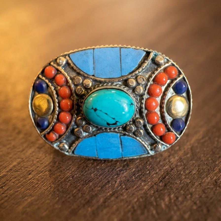 Decorative brooch with colorful stones on a wooden surface