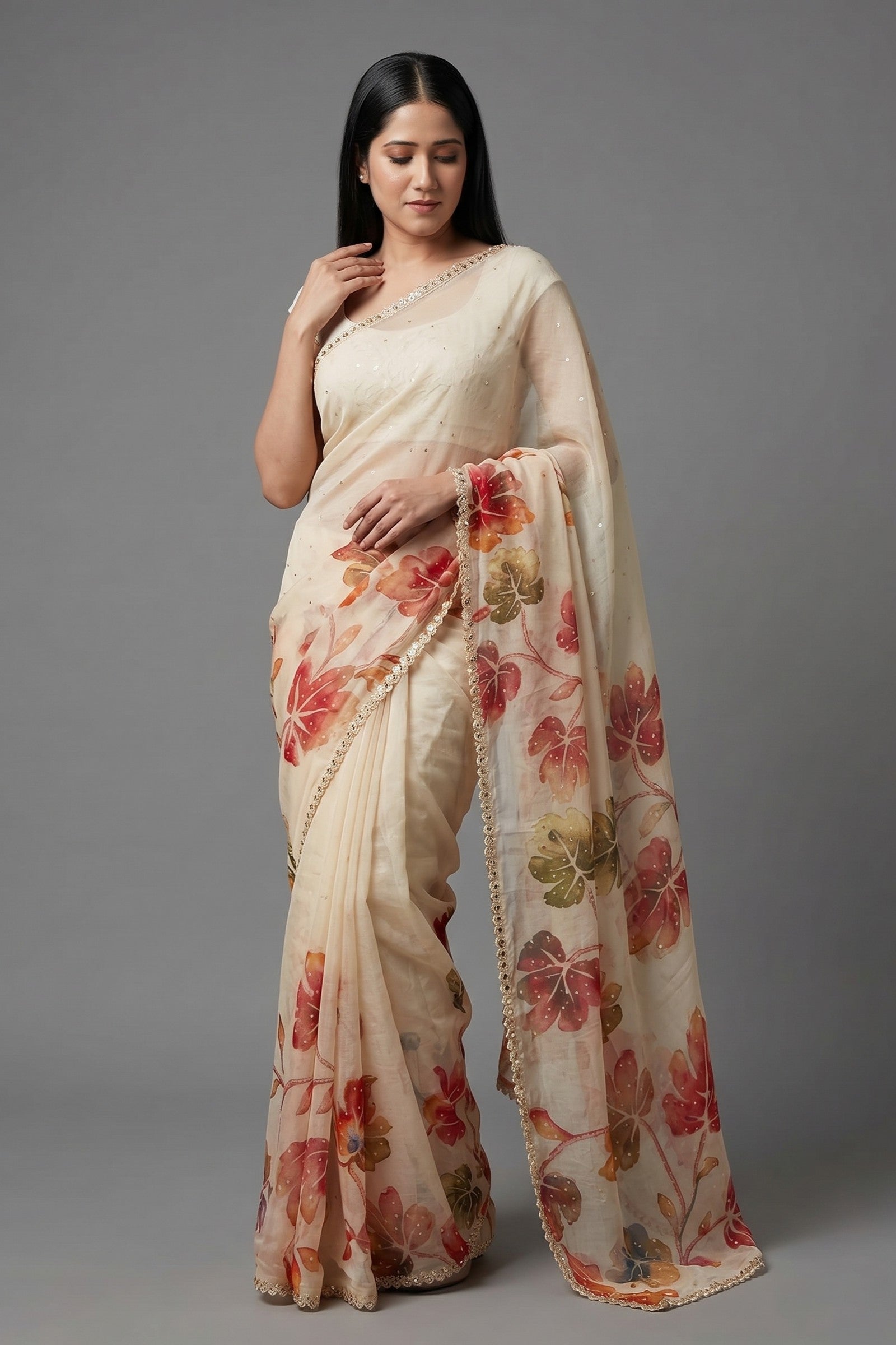 Woman wearing a floral saree against a gray background