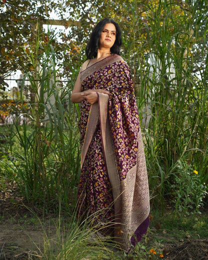 Woman wearing a floral saree standing in a garden