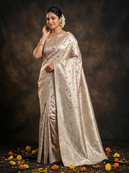 Woman wearing a traditional saree with a floral pattern against a dark background